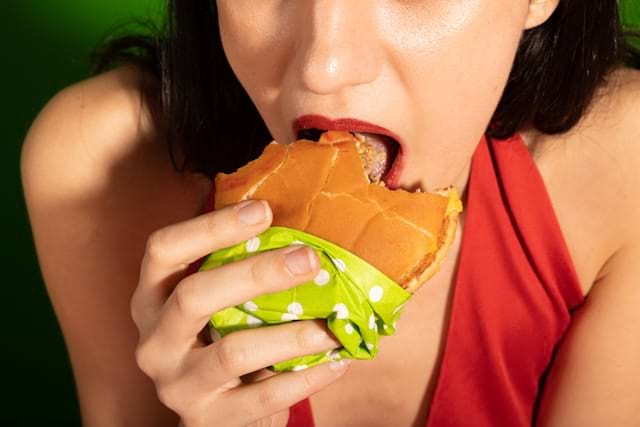 Woman eating a hamburger